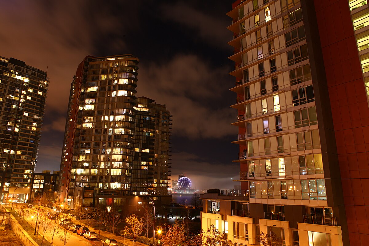 Vancouver downtown condo towers at dusk, viewed from Cambie Bridge